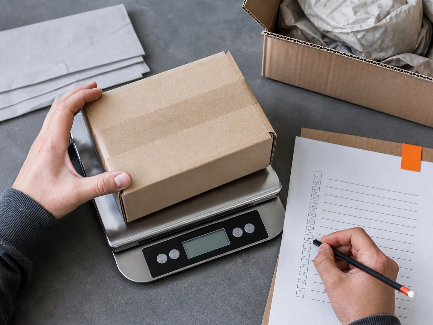 Parcel weight and notes being checked at a worktable